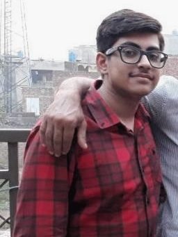 Hamdan as an overweight teenager, in a red checked shirt